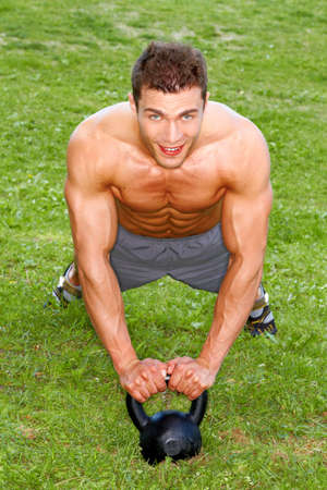 Handsome man Doing exercises with weightの写真素材