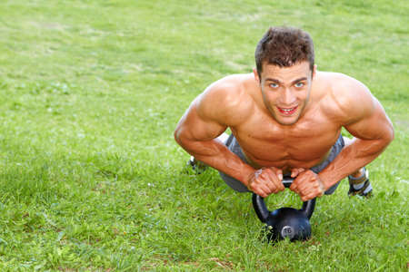 Handsome man Doing exercises with weightの写真素材