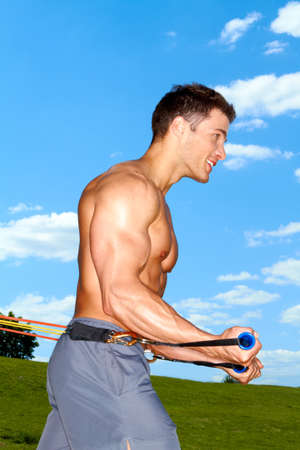 Muscular man doing workout in the parkの写真素材