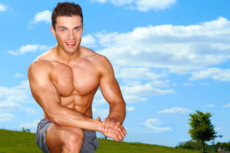 Sporty muscular man at green fieldの写真素材