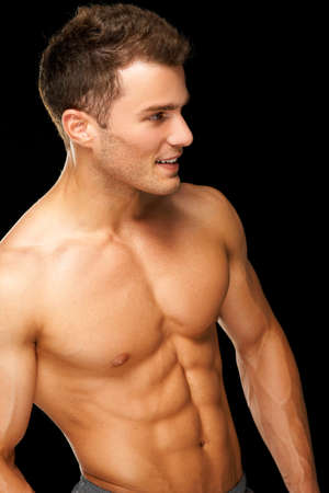 Portrait of a male athlete muscular isolated on a black backgroundの写真素材