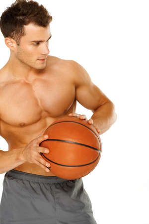 Portrait of a young male basketball player gripping the ballの写真素材