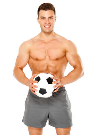 Fit muscular man with soccer ball on white backgroundの写真素材