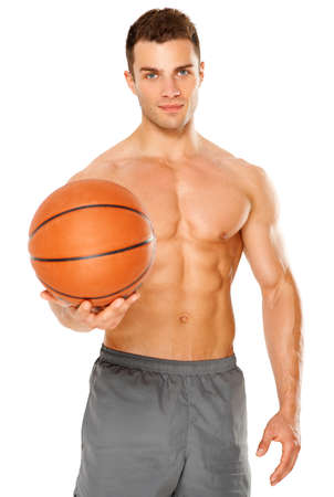 Handsome basketball player holding ball on white backgroundの写真素材