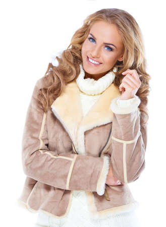 Cute woman wearing modern winter fur jacket , isolatedの写真素材
