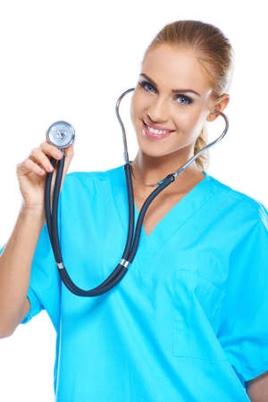 Pretty young doctor holding her stethoscope while isolated on whiteの写真素材