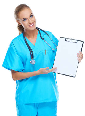Beautiful gorgeous nurse holding writingpad and smiling at the cameraの写真素材