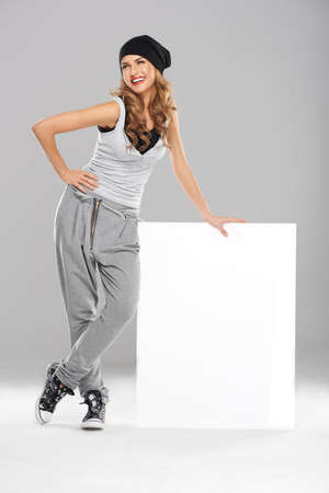 Cute female modern dancer holding white empty boardの写真素材
