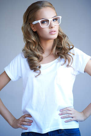 Portrait of a lovely young girl wearing stylish white glassesの写真素材