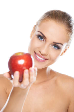 Smiling beauty holding red apple while isolated on whiteの写真素材