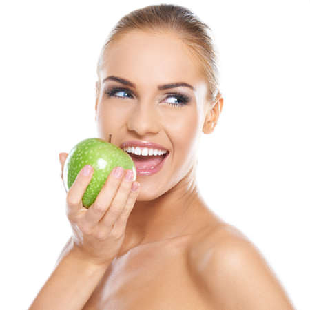 Smiling beauty holding green apple while isolated on whiteの写真素材