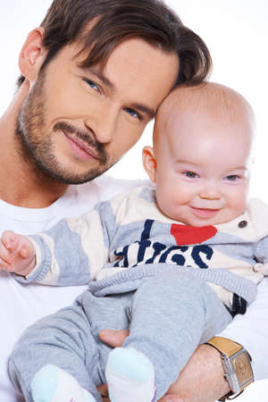 Closeup portait of a happy smiling father and beautiful beaming baby isolated on whiteの写真素材