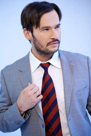 Portrait of a handsome Caucasian young beard man wearing suit and necktieの写真素材