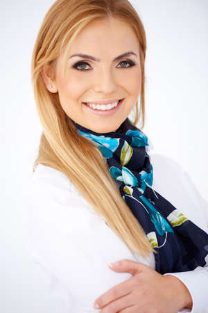 Portrait of a pretty and smiling airline hostess. Isolated on whiteの写真素材