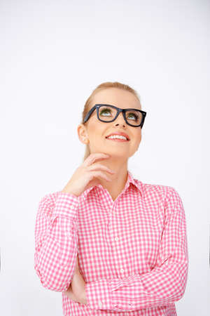 Pretty girl, smiling and looking up, wearing black framed glasses. White backgroundの写真素材