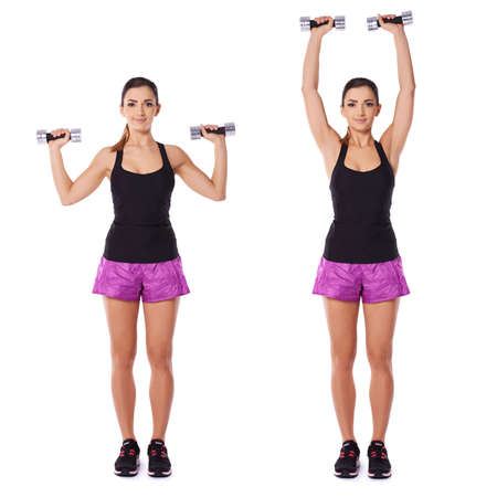 Woman working out with dumbbells shown in two positions standing facing the camera with the dumbbell at shoulder height flexing and extending her armの写真素材