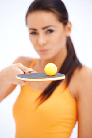 Sporty table tennis player with holding rocket and balancing ballの写真素材