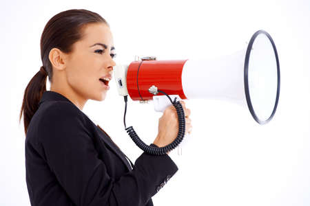 Cute business woman screaming loudly thru big megaphoneの写真素材