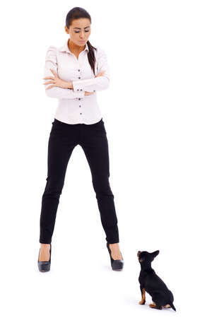 Sexy brunette model posing against small sitting ratter dogの写真素材