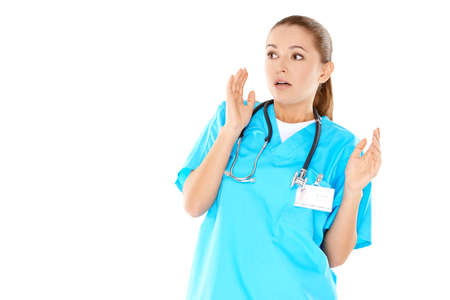 Pretty young nurse is very worried about what she saw  isolated on whiteの写真素材