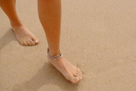 Bare Feet Coated in Sand Walking on Beachの写真素材