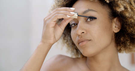 Close up of african american woman face with mascara brushの写真素材