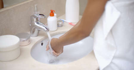 Close up of a girl washes hands in the bathroomの写真素材
