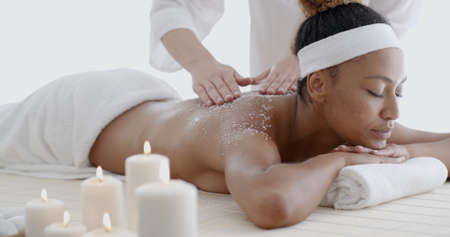 Close-up of a beautiful black woman getting spa treatmentの写真素材
