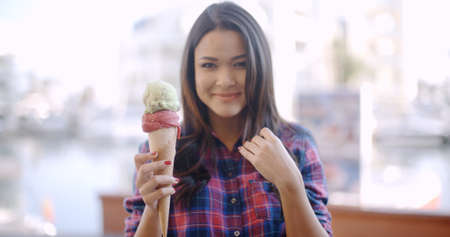 Girl eating a delicious ice cream in summer hot weather