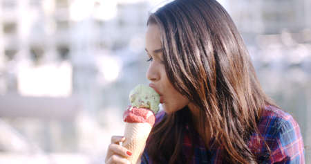 Girl eating a delicious ice cream in summer hot weather