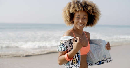 Positive young woman flirting on camera on the beach in