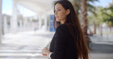 Beautiful Business Woman Standing on Malaga Promenade and Looking Somewhere  onの写真素材