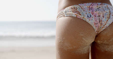Sexy female buttocks in panties on the beachの写真素材