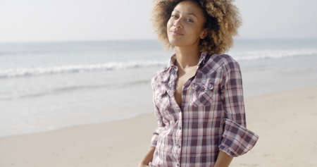 Happy and beautiful african american young woman on a beach slow motion