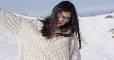 Happy young woman in snowy landscape