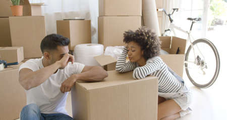 Exhausted couple taking a break from packing