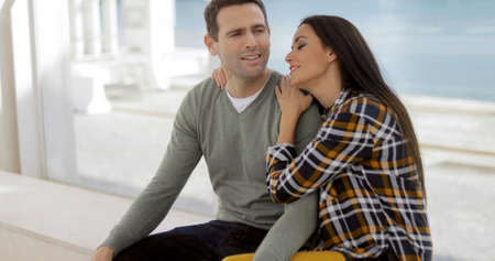 Romantic young couple sitting watching