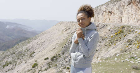 Young smiling sportive woman posing on natureの写真素材