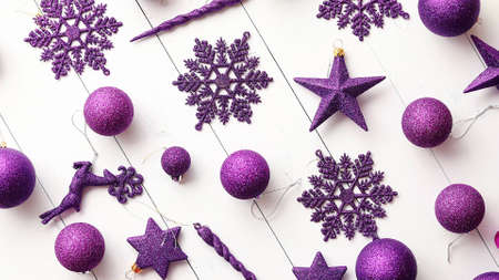 Christmas purple collection, balls and decorative ornaments, on white wooden background.の写真素材