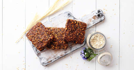 Closeup of whole grain bread with sunflower seeds on a rustic wooden board. Top view.の写真素材
