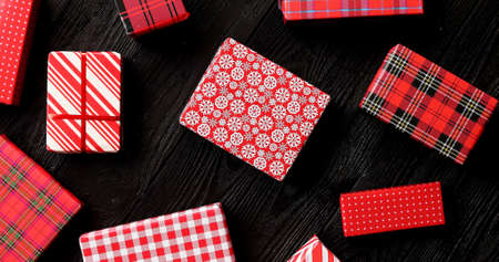 From above view of wrapped Christmas presents laid on wooden background
