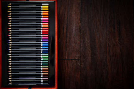 Selective focus shot of a row of professional colored pencils placed in case.