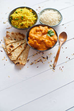 Fresh and tasty Butter Chicken served in ceramic bowl. Indian mild traditional dish. With rice and...