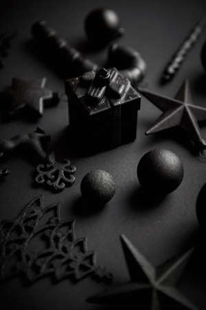 Christmas minimalistic and simple composition in mat black color. Christmas gifts, decorations on black background. Flat lay, top view .の写真素材