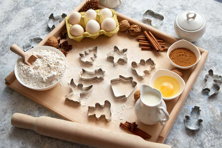Delicious fresh and healthy ingredients for Christmas gingerbread. Placed on a wooden pastry board. View from above.の写真素材
