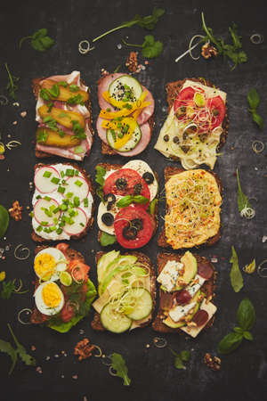 Top view of different decorated sandwiches as appetizer. Healthy food. Vegetable meal concept.の写真素材