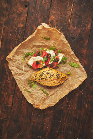 Healthy food concept. Sandwiches with hummus, mozarella, tomato, black olives. Placen on rusty wooden table. Top viewの写真素材