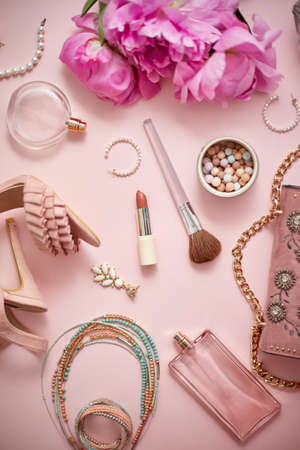 Beauty and fashion accessories and gadgets. Femine concept. Flat lay on pink theme background. With shoes, purse, cosmetics, flower.の写真素材