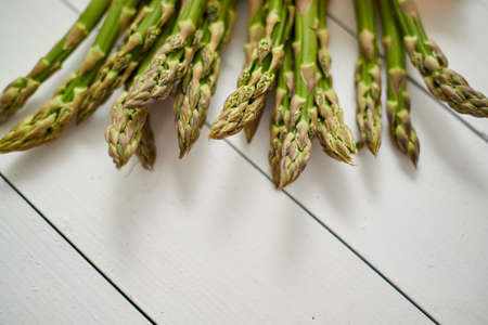 Fresh green asparagus in a brown paper bag. Healthy eating concept. Food for vegetarians. Raw vegetable. Top view.の写真素材