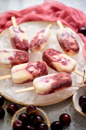Fresh cream and cherry homemade placed on white ceramic plate with fruits and textile. Top view, flat lay.の写真素材